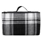 Black and white plaid folded blanket with a handle on top.
