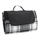 Black and white plaid folded picnic blanket with a carrying handle.