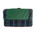 A folded, plaid picnic blanket with a green flap and handle.