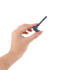 Hand holding a small, blue, whale-shaped object against a white background.
