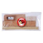 A clear plastic bag contains a wooden ruler, two wooden pencils, an eraser, and a sharpener. In the center is a round red emblem with a cartoon ladybird and the text Ladybird Learning.