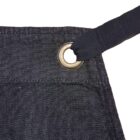 Close-up of a dark denim fabric with a metal eyelet. A black strap is threaded through the eyelet, highlighting the texture and stitching detail of the material.