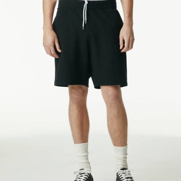 Person wearing black shorts, white t-shirt, white socks, and black sneakers, standing upright.