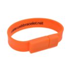 Orange USB wristband with a website link on it.