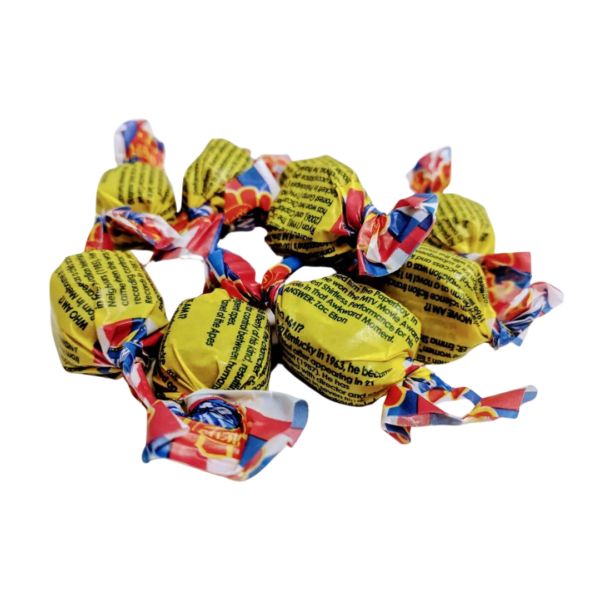 A pile of wrapped Allens Fantales Bags candies displays colorful wrappers with yellow, red, and blue designs. The candies have twists at both ends, and the text on the wrappers is partially visible.