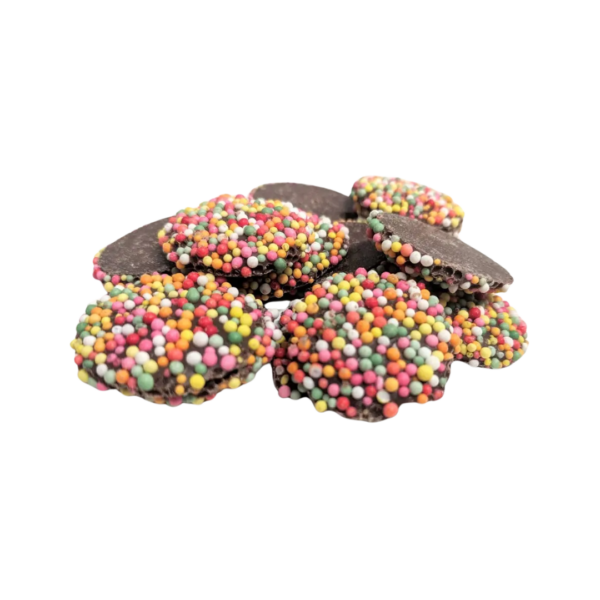 A pile of Allens Freckles Bags lies on a white background, displaying delightful chocolate buttons topped with vibrant pink, yellow, green, and blue sprinkles.