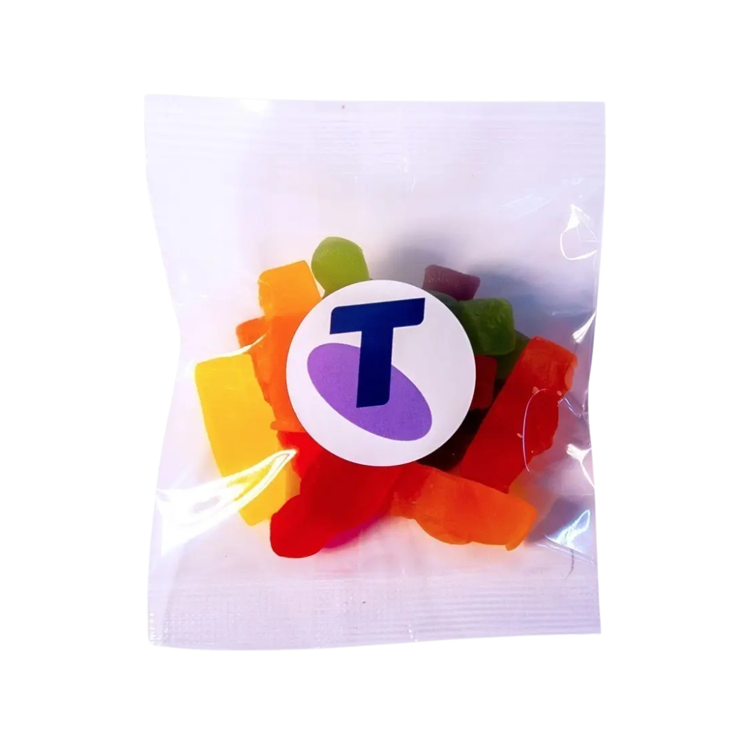 A clear plastic packet filled with vibrant gummy candies is shown. The white label reads Allens Jellybabies Bags and features a stylized purple and blue letter T.