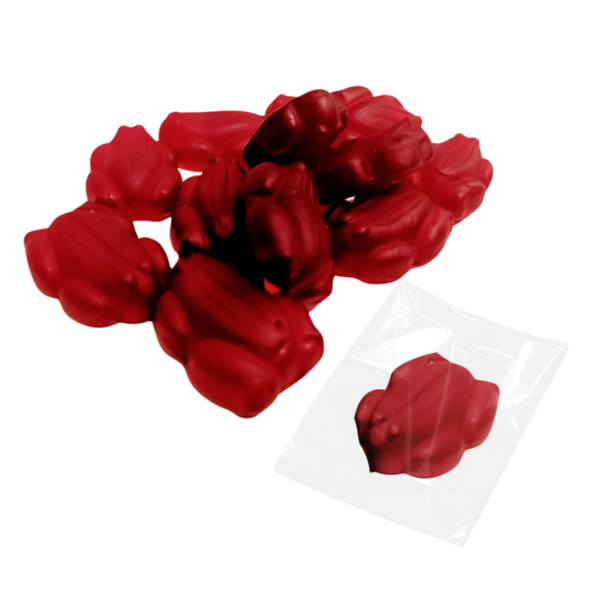 Allens Red Frogs gummy candies, bright and smooth, scatter on a white background with one uniquely set apart, wrapped individually in clear plastic.
