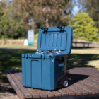 Cooler Boxes with Wheels 31L on a picnic table in a sunny park.