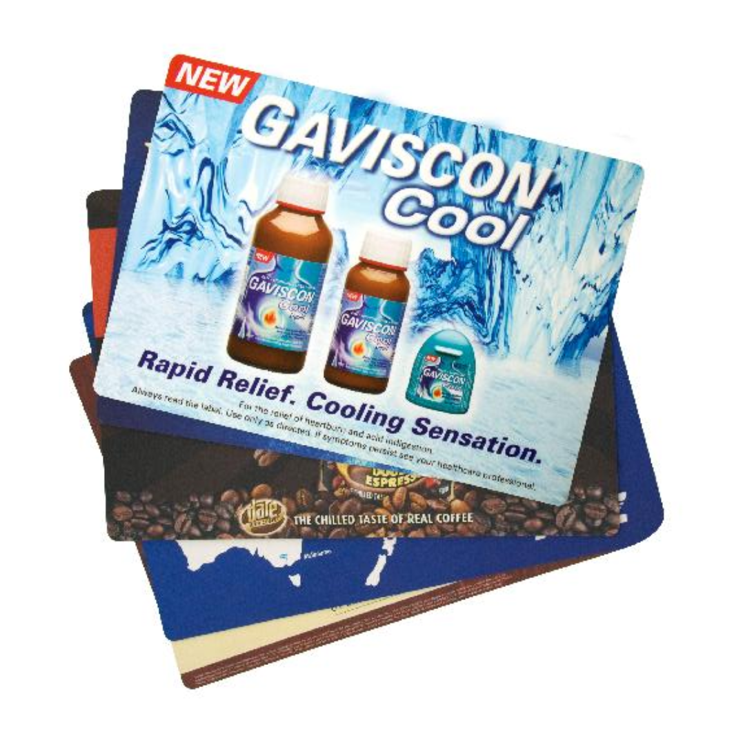 A stack of vibrant Deluxe Counter Mats showcases Gaviscon Cool imagery with two bottle designs and the slogan: Rapid Relief. Cooling Sensation, adding a stylish touch to any setting.
