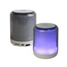 Two cylindrical wireless speakers; one lit in purple, both with gray tops and white bases.