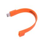 Orange USB bracelet with curved shape and connector on one end.
