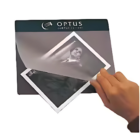 Hand placing a photo on a Flip Top Customised Mouse Pad.