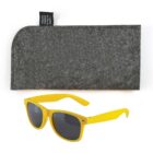 Yellow sunglasses with dark lenses are placed in front of a textured gray case, which features a small black tag.