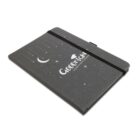 A gray notebook with a black elastic band, featuring a crescent moon and stars design. The words GOODNIGHT Sleepyhead are printed on the cover.