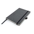 A closed, dark gray hardcover notebook with a black elastic band and a bookmark ribbon. The notebook has slightly rounded corners and a pen loop on the side. It is positioned at an angle on a white background.