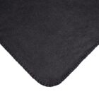 Close-up of a black fabric with a soft, plush texture. The edge features a simple stitched seam. The material appears smooth and velvety, catching light in a way that highlights its luxurious and cozy appearance.