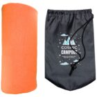 An orange rolled-up camping blanket next to a black drawstring bag with a design that reads, Cosmic Campout: Explore the Wilderness, One Star at a Time, featuring stars, clouds, and a tent graphic.