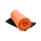 A rolled orange blanket placed on a black fabric pouch against a white background.