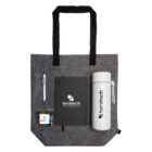 Gray tote bag with a pen, notebook, bottle, and candy container displaying the teratech logo.