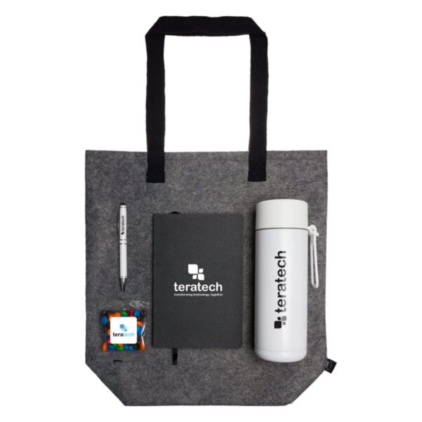 Gray tote bag with a pen, notebook, tumbler, and candy pack, all branded with teratech.