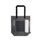 Gray felt tote bag with a notebook, pen, candy, and white thermos on it.