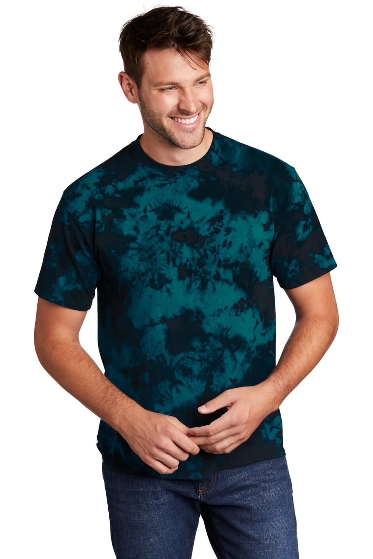 Smiling man in a blue tie-dye shirt and jeans against a white background.