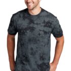 Man wearing a black tie-dye T-shirt and jeans, smiling while standing.