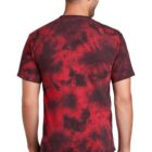 Man in red and black tie-dye shirt and jeans, facing away.
