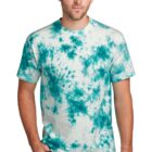 Man wearing a blue tie-dye t-shirt and jeans, standing against a plain white background.