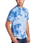 Man wearing a blue tie-dye t-shirt and jeans, standing against a plain background.