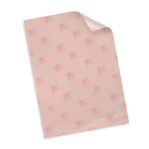 A sheet of pink paper with multiple red BB logos printed on it in a repeating pattern. The top right corner of the paper is slightly curled. The background is white.