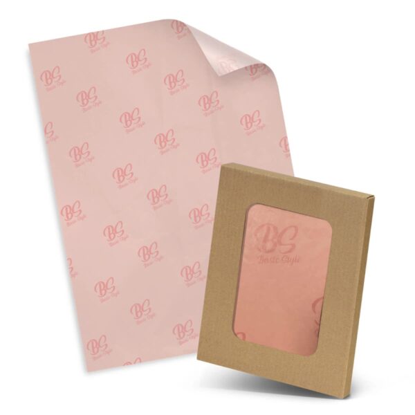 Transparent pink tissue paper with Beasto Style logos lies next to a brown cardboard box with a clear window, showcasing the pink tissue inside. The box and tissue have a stylish and coordinated appearance.
