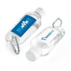 Two clear hand sanitizer bottles with white caps and attached silver carabiners. One bottle has a blue SUMMIT label and the other has a white label with a heart symbol and the word humankind.