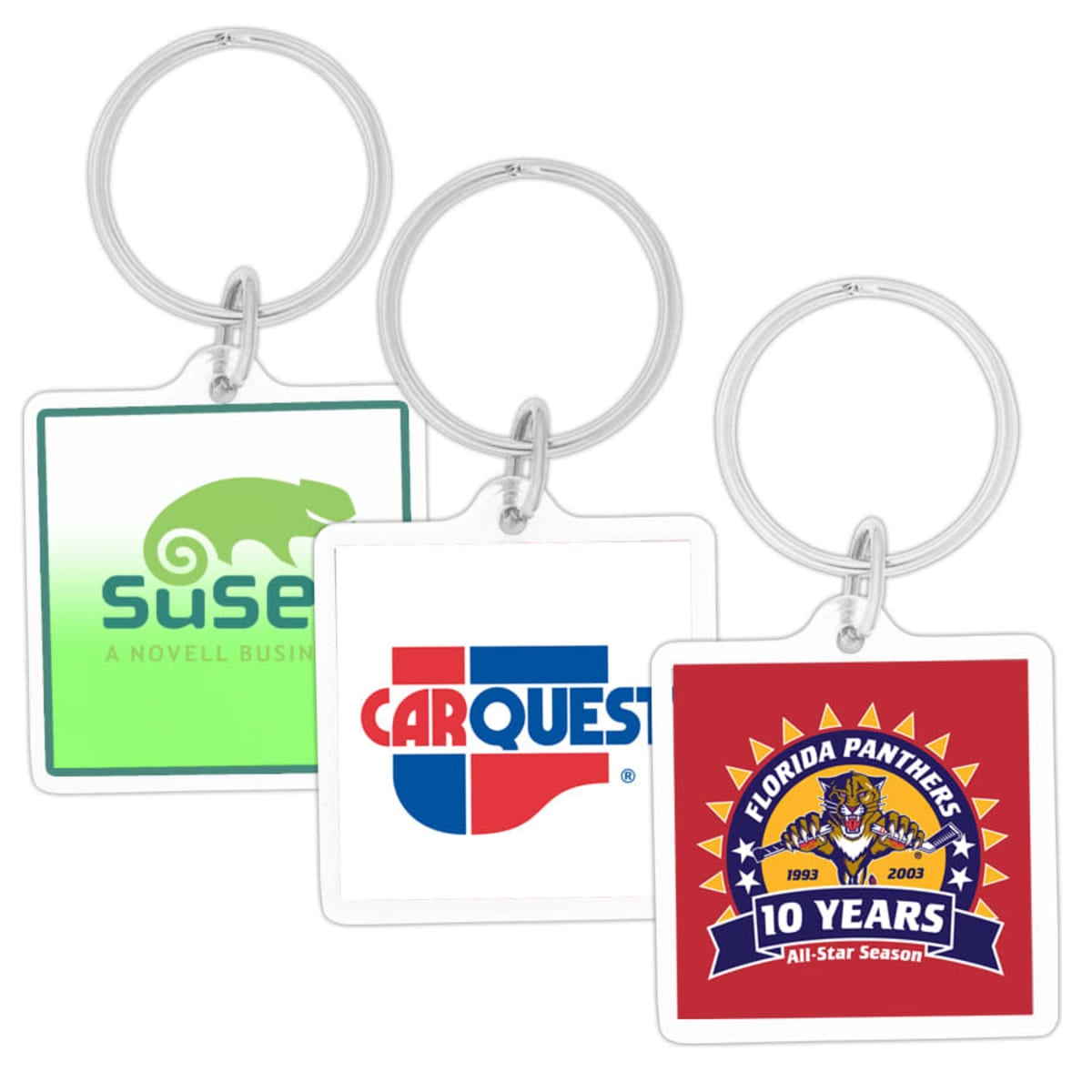 Three square keychains with different designs: a green gecko with SUSE A Novell Business, the CARQUEST logo in blue and red, and a Florida Panthers 10 Years All-Star Season emblem with a panther and hockey sticks.