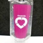 A small, clear hand sanitizer bottle with a purple label featuring the text donate life and a heart made of arrows. It has a metal clip attached to the top. The background is black and white.