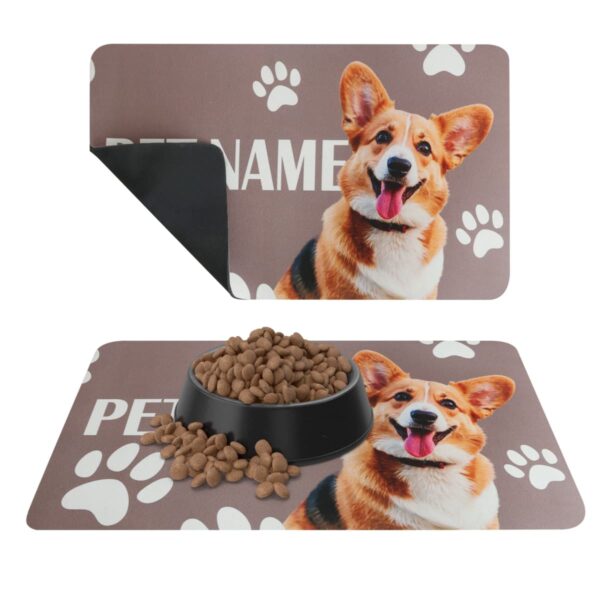 Two pet mats with a corgi image; one mat is plain, and the other has a black food bowl and kibble on it. Both mats have paw prints and the placeholder text PET NAME.