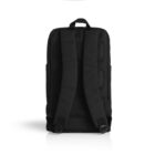 The image shows a black backpack positioned upright on a white background, displaying its padded shoulder straps and back panel. The simple design is highlighted, and there are no visible logos or additional features.
