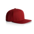 A red baseball cap with a flat brim is displayed against a white background. The side view highlights the caps structure and stitching details.