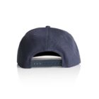 A navy blue baseball cap shown from the back, featuring an adjustable strap with multiple holes and a plastic snap closure. The cap is placed on a reflective white surface.