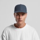 A person wearing a dark blue baseball cap and a plain white shirt, looking directly at the camera against a light gray background.