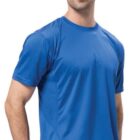 A man wearing a Cool breathable tee in blue and jeans stands against a white background. He has short, dark hair with a light beard and is smiling subtly at the camera.