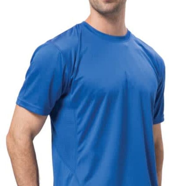 A man wearing a Cool breathable tee in blue and jeans stands against a white background. He has short, dark hair with a light beard and is smiling subtly at the camera.