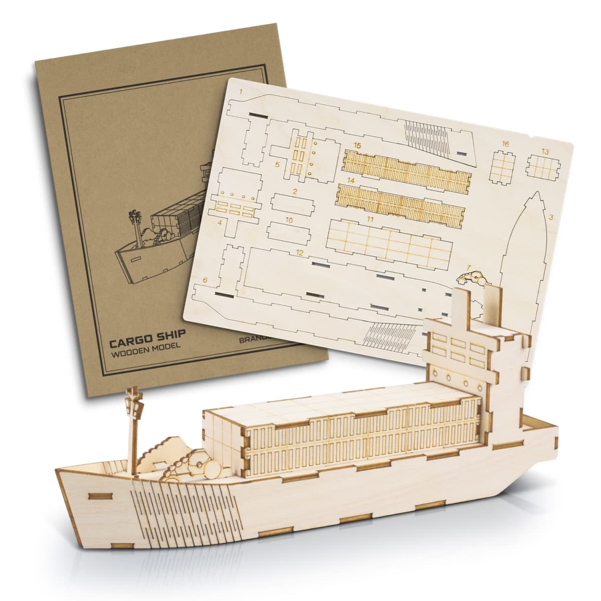 A wooden cargo ship model kit with assembly instructions. The kit includes flat wooden pieces with outlines of ship parts, a cardboard instruction manual with a ship illustration, and an assembled model ship with visible container details.