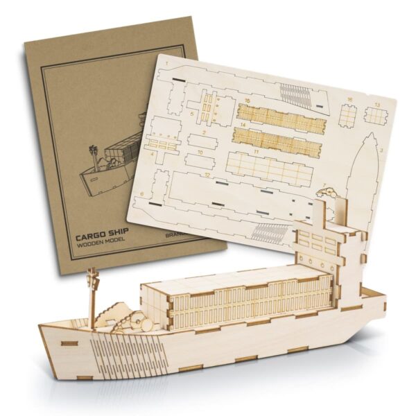A wooden cargo ship model kit is displayed, featuring a detailed blueprint and cut-out pieces. The model, partially assembled, showcases a cargo ship with distinct decks and cabins. The packaging is visible in the background.