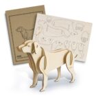 A 3D wooden puzzle of a dog is assembled in the foreground, with two sheets in the background: one showing the puzzle pieces with outlines and numbers, and the other with an illustration of a dog.