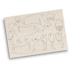 A wooden puzzle board featuring cut-out pieces shaped like dog body parts, including legs, paws, and head. Each piece is numbered for assembly, forming a complete dog when put together. The wood has a smooth finish and light color.