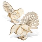 Two 3D wooden bird puzzles with intricate feather details. The models are assembled, showing side views, highlighting their natural wood texture and layered construction. The tail feathers are prominently displayed.