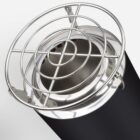 Close-up of a cylindrical black container with a metallic lid and a wire grid on top. The shiny surface reflects light, and the grid is secured with clamps, creating a modern industrial look.