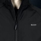 A person wearing a black Swiss Peak jacket with a zip-up front. The jacket features the Swiss Peak logo on the chest. The background is dark.